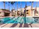 Relaxing community pool with surrounding lounge chairs at 6885 Tamarus St # 201, Las Vegas, NV 89119