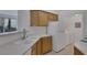 Kitchen with white appliances and light wood cabinets at 7119 S Durango Dr # 107, Las Vegas, NV 89113