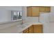 Kitchen area with light wood cabinets and white appliances at 7119 S Durango Dr # 107, Las Vegas, NV 89113