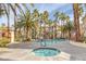 Community pool and spa with surrounding lounge chairs at 7119 S Durango Dr # 107, Las Vegas, NV 89113