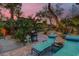 Landscaped backyard with lounge chairs and grill at 7436 Oak Grove Ave, Las Vegas, NV 89117