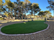 Community putting green with artificial turf and rock border at 7436 Oak Grove Ave, Las Vegas, NV 89117