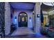 Grand entryway with a dark blue door, stone accents, and blue lighting at 7436 Oak Grove Ave, Las Vegas, NV 89117