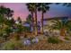 Landscaped front yard with palm trees and drought-tolerant plants at 7436 Oak Grove Ave, Las Vegas, NV 89117