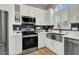 Modern kitchen with stainless steel appliances and a farmhouse sink at 7436 Oak Grove Ave, Las Vegas, NV 89117