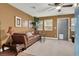 Cozy living room featuring a brown leather couch and hardwood floors at 7436 Oak Grove Ave, Las Vegas, NV 89117