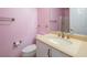 Clean bathroom with pink walls and updated vanity at 7491 Speedwell Cavern St, Las Vegas, NV 89139