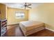 Spacious bedroom with large bed, ceiling fan, and hardwood floors at 7491 Speedwell Cavern St, Las Vegas, NV 89139