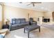 Living room with gray reclining sofa and coffee table at 7491 Speedwell Cavern St, Las Vegas, NV 89139