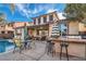 Outdoor kitchen and patio furniture adjacent to the pool and house at 7700 Tierra Montanosa Ave, Las Vegas, NV 89179