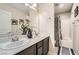 Double vanity bathroom with dark brown cabinets at 7700 Tierra Montanosa Ave, Las Vegas, NV 89179