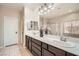 Double vanity bathroom with modern dark brown cabinets and a shower at 7700 Tierra Montanosa Ave, Las Vegas, NV 89179