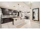 Modern kitchen with dark cabinets, granite counters and island at 7700 Tierra Montanosa Ave, Las Vegas, NV 89179