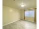 Well-lit bedroom with tile flooring and window at 7732 Beverly Hills Dr, Las Vegas, NV 89147