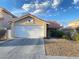 Single-story home with a two-car garage and desert landscaping at 7732 Beverly Hills Dr, Las Vegas, NV 89147