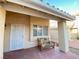 Covered front porch with a small seating area at 7732 Beverly Hills Dr, Las Vegas, NV 89147