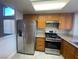 Modern kitchen features stainless steel appliances and wood cabinets at 7732 Beverly Hills Dr, Las Vegas, NV 89147