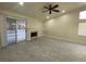 Bright living room with tile floors, fireplace, and access to backyard at 7732 Beverly Hills Dr, Las Vegas, NV 89147