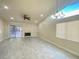 Bright living room with tile floors, fireplace, and access to backyard at 7732 Beverly Hills Dr, Las Vegas, NV 89147