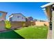 Landscaped backyard featuring artificial turf and a brick patio at 859 Benning St, Henderson, NV 89011