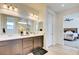 Modern bathroom with double vanity, large mirror, and a walk-in shower at 859 Benning St, Henderson, NV 89011