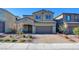 Two-story home with attached garage and landscaped front yard at 859 Benning St, Henderson, NV 89011