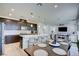 Modern kitchen with dark cabinetry, large island, and dining area at 859 Benning St, Henderson, NV 89011