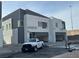 New construction home with gray siding and a blue door at 8629 Ensworth St 111, Las Vegas, NV 89123