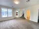 Spacious living room with carpeting, fireplace, and view of staircase at 8970 College Green St, Las Vegas, NV 89148