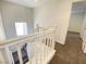 Upstairs hallway with white railing and carpet at 8970 College Green St, Las Vegas, NV 89148