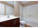 Bathroom with tub, toilet, and dark brown vanity at 9378 Hilgard Ave, Las Vegas, NV 89178