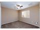 Spacious bedroom with ceiling fan and neutral carpeting at 9378 Hilgard Ave, Las Vegas, NV 89178