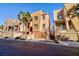 Three story tan stucco home with attached garage at 9378 Hilgard Ave, Las Vegas, NV 89178