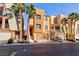 Three story tan stucco home with attached garage at 9378 Hilgard Ave, Las Vegas, NV 89178