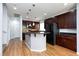 Modern kitchen with dark wood cabinets and granite countertops at 9378 Hilgard Ave, Las Vegas, NV 89178