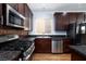 Kitchen with stainless steel appliances and dark wood cabinets at 9378 Hilgard Ave, Las Vegas, NV 89178