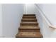 Carpeted staircase with simple white railing at 9378 Hilgard Ave, Las Vegas, NV 89178