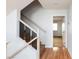 Modern staircase with dark wood accents and light-colored wood railing at 9378 Hilgard Ave, Las Vegas, NV 89178