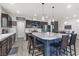 Bright kitchen boasts an island with seating and dark wood cabinetry at 9635 Stoney Mesa Ct, Las Vegas, NV 89139