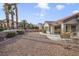 Landscaped backyard with gravel and palm trees at 9921 Woodhouse Dr, Las Vegas, NV 89134