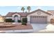 Single-story home with attractive landscaping and a two-car garage at 9921 Woodhouse Dr, Las Vegas, NV 89134