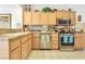 Well-equipped kitchen with light wood cabinets and granite countertops at 9921 Woodhouse Dr, Las Vegas, NV 89134