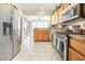 Bright kitchen featuring stainless steel appliances and wood cabinets at 9921 Woodhouse Dr, Las Vegas, NV 89134