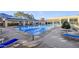 Community pool with lounge chairs and covered seating at 9921 Woodhouse Dr, Las Vegas, NV 89134