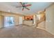 Spacious living room with a view of the kitchen and staircase at 9936 Fountain Walk Ave, Las Vegas, NV 89149