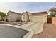 Single-story house with a two-car garage and desert landscaping at , Las Vegas, NV 89148