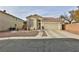 Single-story house with a two-car garage and landscaped front yard at , Las Vegas, NV 89148