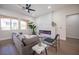 Living room with electric fireplace, gray sectional, and hardwood floors at 10624 Mission Lakes Ave, Las Vegas, NV 89134