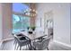 Dining area with wooden table, chandelier, and kitchen view at 1374 Coppelia Ct, Henderson, NV 89052