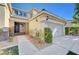 Front entrance with wrought iron door and landscaping at 1374 Coppelia Ct, Henderson, NV 89052